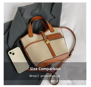 Detailed size comparison of the canvas bucket bag showing dimensions with a smartphone