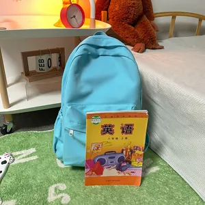 Light blue canvas backpack for students with a front zipper pocket and large capacity