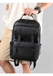 Close-up of black leather business backpack with lychee texture and magnetic flap details