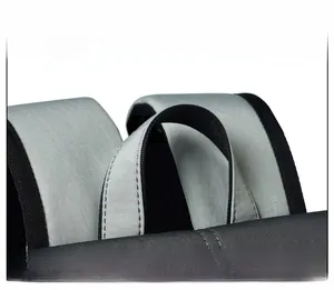Detail view of the durable gray nylon handle and padded shoulder straps on the backpack