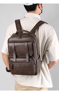 Detail of large dark brown faux leather backpack with litchi texture and adjustable straps