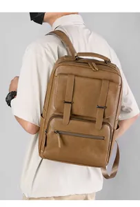 Brown faux leather business backpack featuring textured litchi grain and multiple compartments