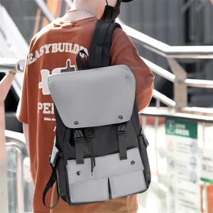 Detail of color-block nylon backpack featuring dual buckle closure and multiple pockets