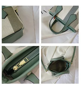 Detail view of striped bucket bag showing zipper, stitching, and metal hardware
