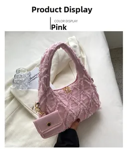 Detailed macro view of pink denim handbag with fringe edges and detachable mini pouch