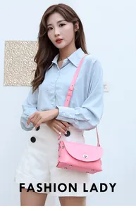Detail of pink faux leather crossbody bag with silver twist lock and rivet accents