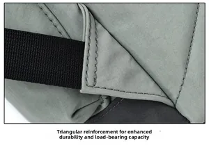 Close-up of reinforced triangular stitching for enhanced durability on a green backpack