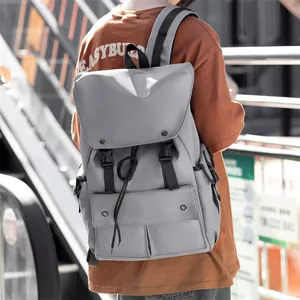 Detailed view of gray nylon backpack featuring dual buckle closure and drawstring design