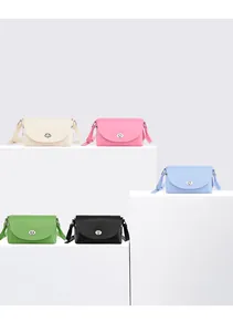Close-up showing five minimalist leather crossbody bags with silver oval twist locks on steps
