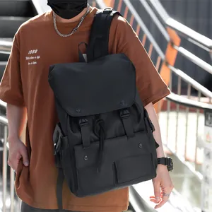 Close-up of black nylon backpack featuring waterproof fabric and multiple utility pockets