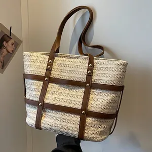 Minimalist straw tote bag with dark brown PU straps and metallic gold rivet details