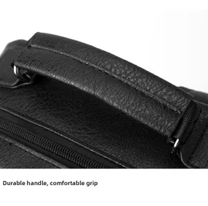 Detail of durable textured leather handle and metal rings on a black business backpack