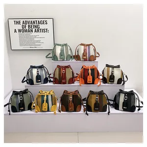 Collection of striped bucket bags in eleven vibrant colors arranged on white steps