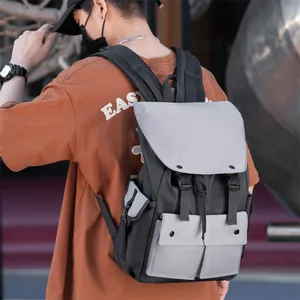 Detail of the high-density nylon backpack showing side pockets and dual buckle closures
