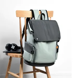 Water-resistant commuter backpack in sage green and charcoal grey for laptop and travel