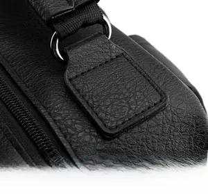 Detail of reinforced stitching and metal D-ring on black lychee pattern leather backpack