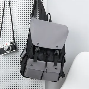 Detail view of the black and grey nylon backpack with buckle closure and multiple pockets