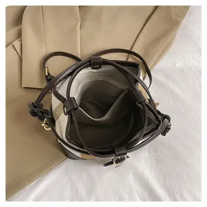 Macro view of bucket bag interior with zipper compartment and magnetic closure
