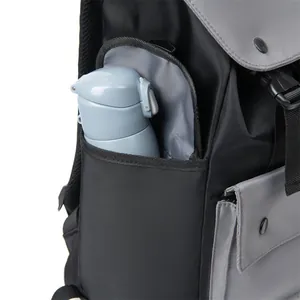Detail of nylon backpack side pocket with a water bottle showing storage capacity