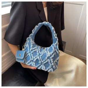 Blue denim handbag with white frayed quilted stitching and mini matching coin purse detail