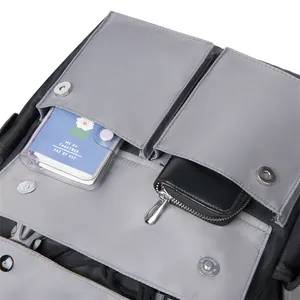 Detail view of nylon laptop backpack with multiple magnetic buckle storage pockets