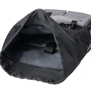 Detail of nylon backpack featuring a drawstring main compartment and padded laptop sleeve