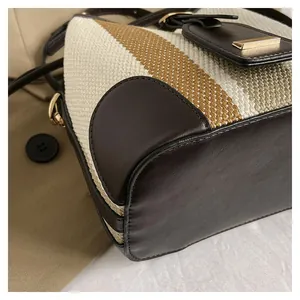 Detailed view of woven canvas texture and premium leather stitching on bucket bag
