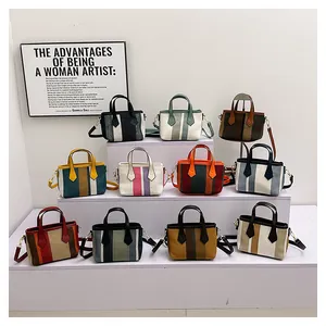 Detailed collection of striped canvas tote bags in various colors on white display stands