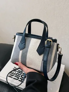 Blue and white striped canvas tote bag with navy leather straps and gold hardware