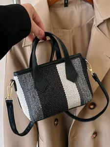 Chic striped canvas tote bag with black leather straps and golden metal hardware