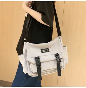 Détail du sac messager en nylon gris clair avec boucles durables et large bandoulière