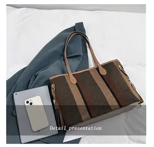 Vertical striped tote bag size comparison with tablet and phone showing large capacity