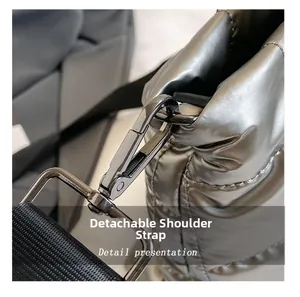 Detail of silver quilted puffer bag showing gunmetal spring hook and detachable strap
