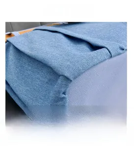 Detailed close-up showing reinforced stitching on high-quality blue denim canvas bag