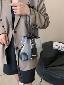 Striped color-block bucket bag with woven texture and black leather trim for women