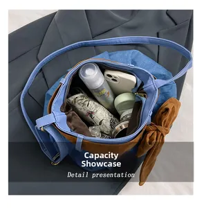 Detail view of denim canvas bag interior showing large capacity and bow decoration