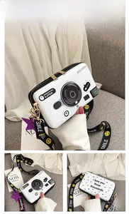 Detailed views of a white camera-shaped crossbody bag with a wide smile-pattern strap