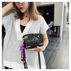Detail of creative camera-shaped crossbody bag with fashion print and star charm