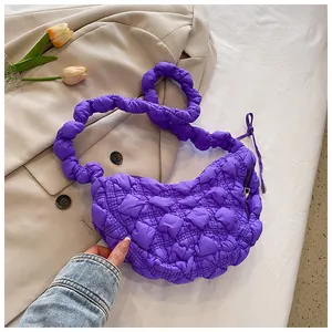 Detalle del bolso nube acolchado morado con correa anudada y tejido suave