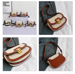 Detail of vintage canvas saddle bag with leather trim and gold metal buckle closure