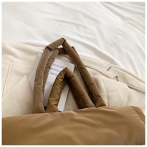 Détails des poignées rembourrées d'un sac cabas matelassé marron en nylon imperméable