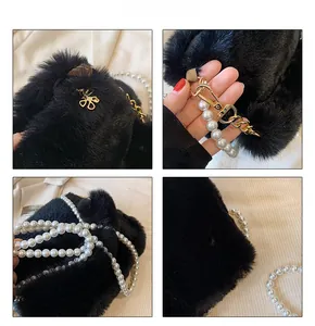 Detail view of plush black faux fur handbag with elegant pearl chain and golden hardware