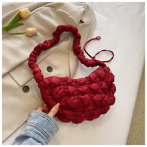 Detalle del bolso nube granate con textura plisada y detalles de cremallera dorada