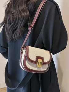 Retro contrast color saddle bag with cream canvas, burgundy leather trim and gold lock