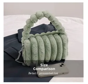 Detail presentation showing pale green plush handbag size compared to a smartphone