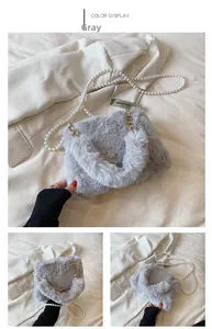 Detail of grey faux fur crossbody bag with elegant pearl chain and golden metal handle