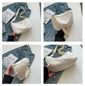 Detailed views of the cream canvas crossbody bag with adjustable strap and zip closure
