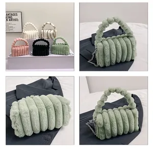 Detail of plush faux rabbit fur handbag with ribbed texture and metal chain strap