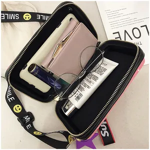 Top view showing camera bag interior storage with smartphone, wallet and glasses