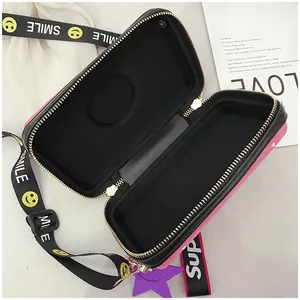 Detailed view of pink camera box bag interior with black lining and Smile shoulder strap
